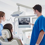 dentist showing a patient their X-rays 