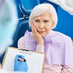 Older woman listening to an emergency dentist in Bella Vista