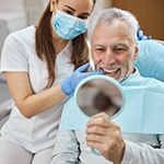 A dentist explaining dental implant care in Bella Vista