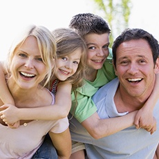 Family smiling outdoors