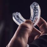 Close-up of hand holding an athletic mouthguard