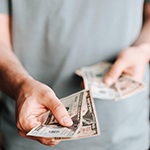 Man extending cash for payment