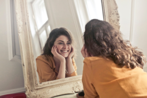 Woman looking at her teeth in mirror