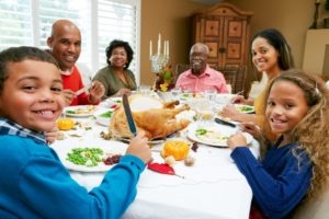 family eating turkey at holiday dinner